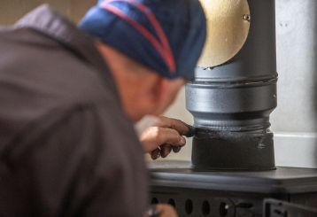 Professional chimney sweep ensuring a clean and safe fireplace in San Jose.